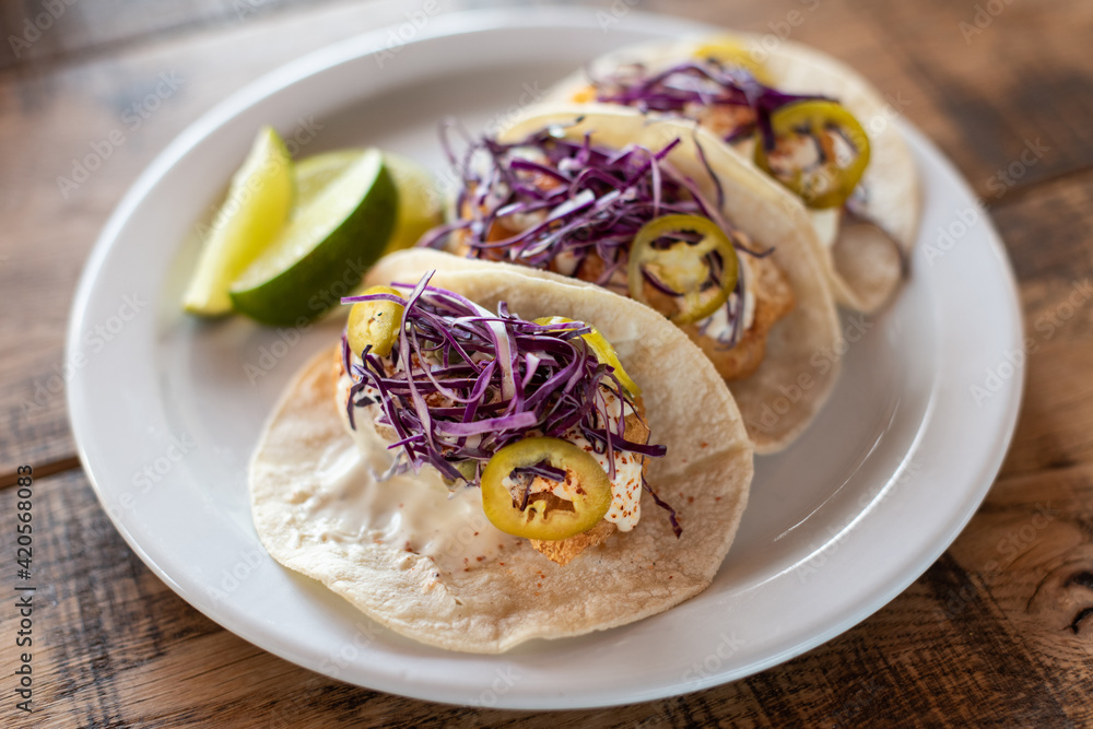 Fish tacos on wooden table. Fish tacos on wooden table.