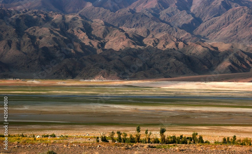 Toktogul reservoir in Kyrgyzstan. Mountain lake. Wavy mountains near the water. photo