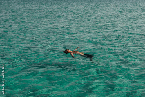 man afloat in ocean water photo