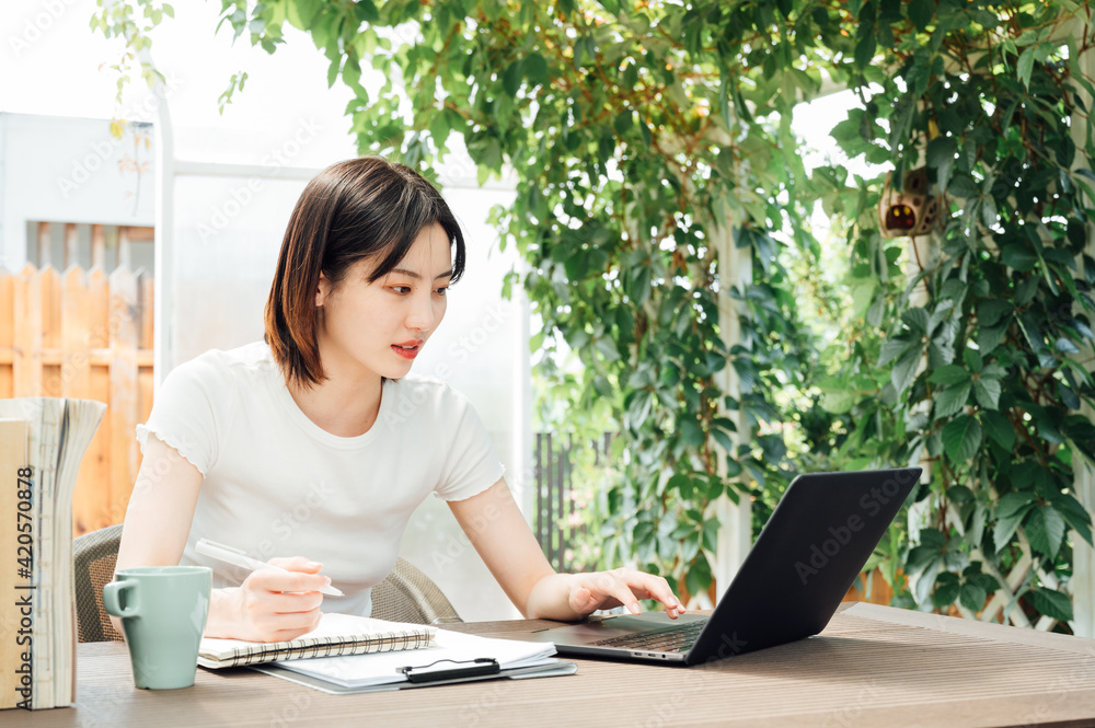 Young girl studying on laptop