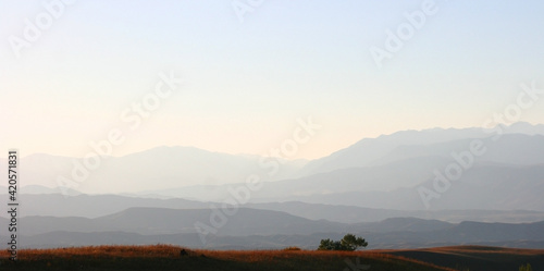 Beautiful sunset in the mountains evening view of the Tien Shan mountain range  Kyrgyzstan  view from the mountain slope