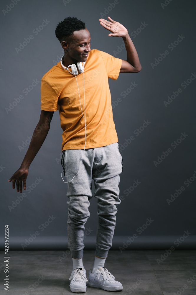 Young black man wearing headphones and dancing Young black man wearing headphones and dancing