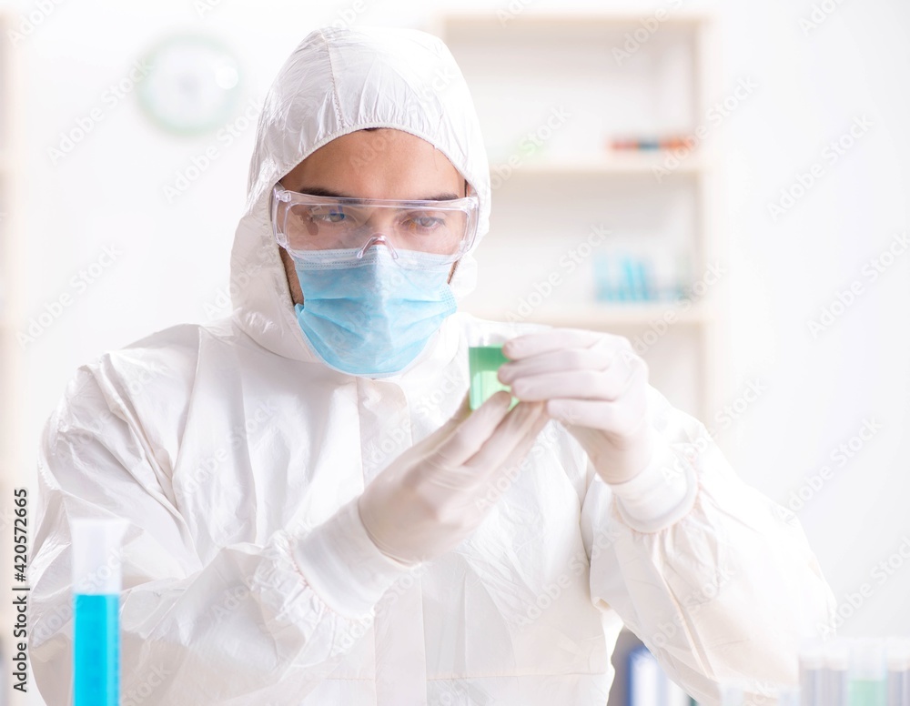 Young chemist student working in lab on chemicals Young chemist student working in lab on chemicals