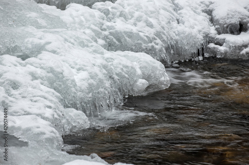 Ice formations by a creek.