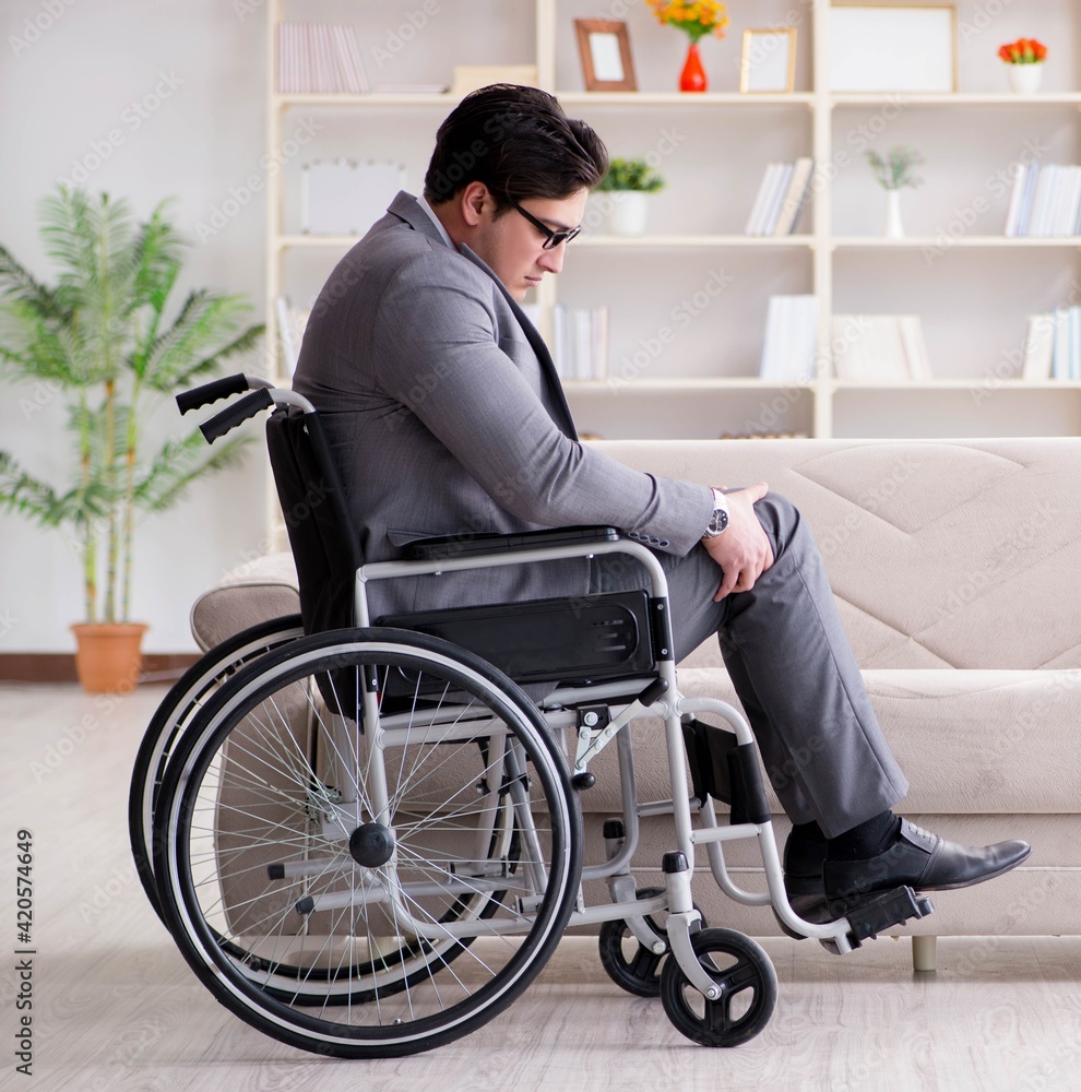 Dsabled businessman on wheelchair working home Dsabled businessman on wheelchair working home