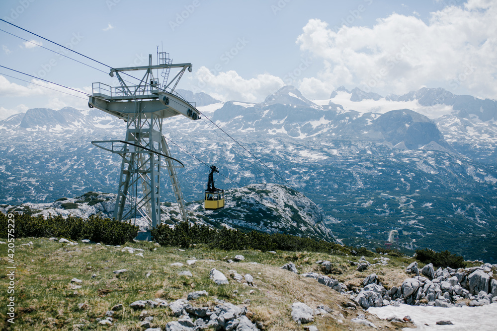 Yellow chairlift or cable car in mountains travelling