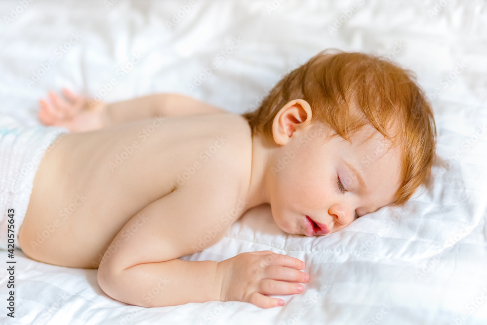 baby sleeps on a white bedspread, clean and minimalistic baby sleeps on a white bedspread, clean and minimalistic