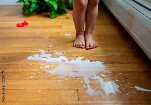 Spilled Milk on Floor with Child's Feet