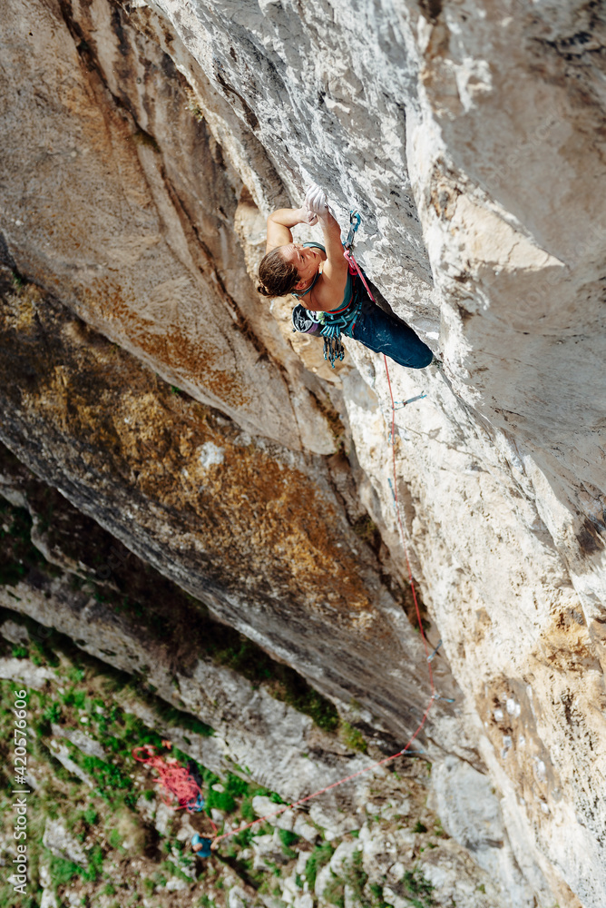 Young climber woman looking her next movement Young climber woman looking her next movement