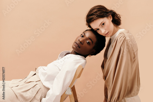 Diverse models resting near chair