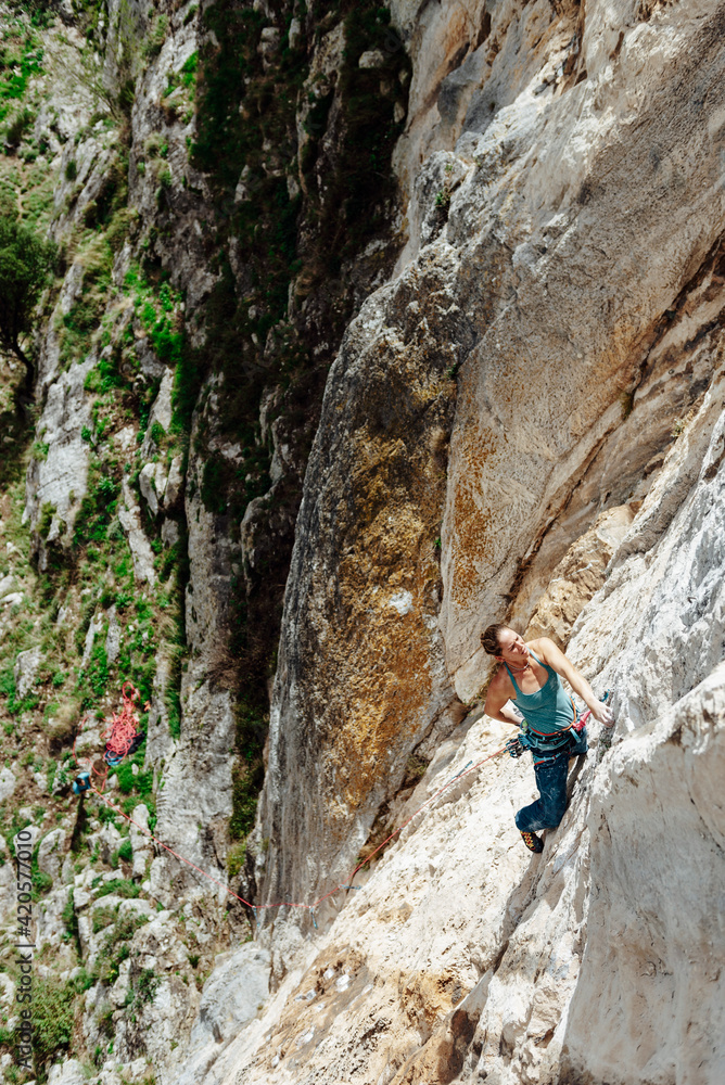 Young climber woman looking her next movement Young climber woman looking her next movement