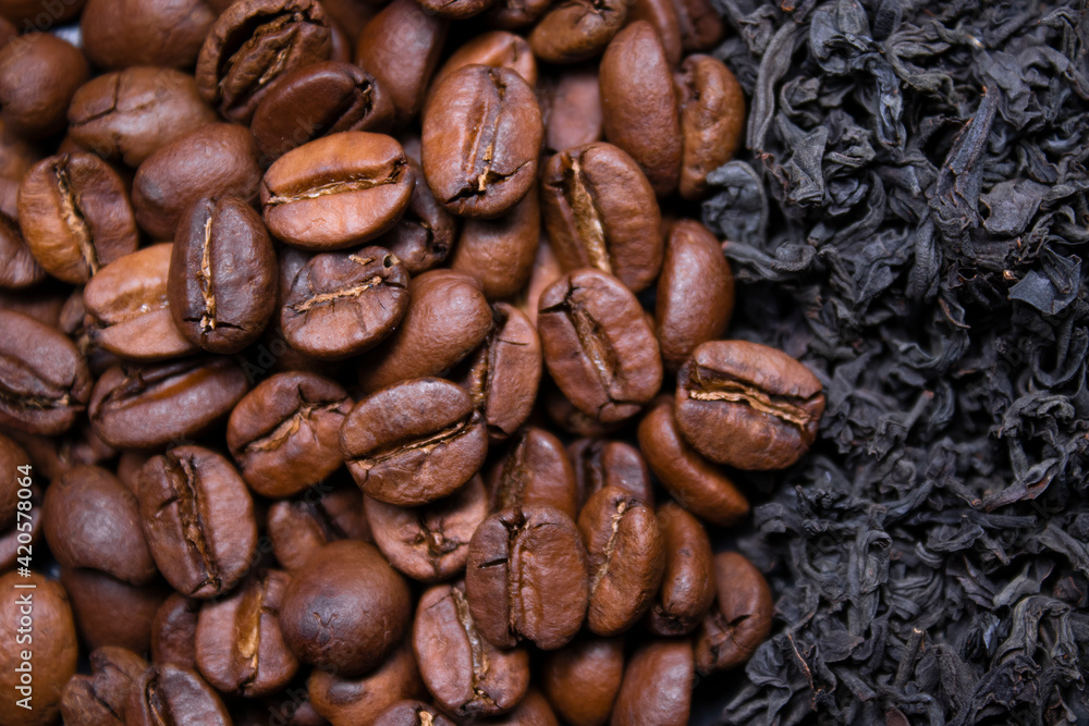 Fototapeta premium pile stack of dried tea leaves and roasted coffee beans seeds: theine vs caffeine. background