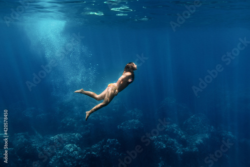 Woman diving in clear sea
