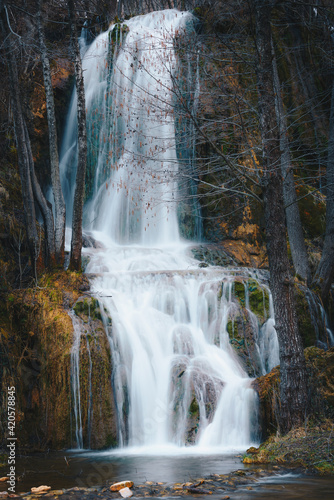Waterfall in winter forest.  