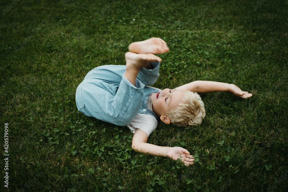 little boy rolling over in the garden little boy rolling over in the garden