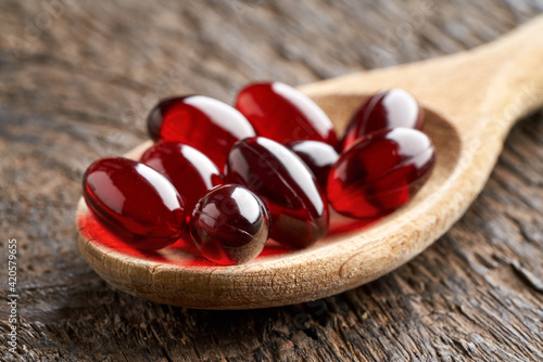 Photos Krill oil pills on a spoon