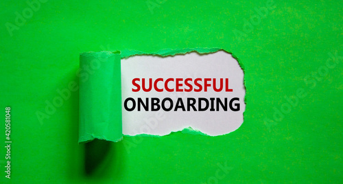 Successful onboarding symbol. Words 'Successful onboarding' appearing behind torn green paper. Beautiful green background. Business, successful onboarding concept, copy space.