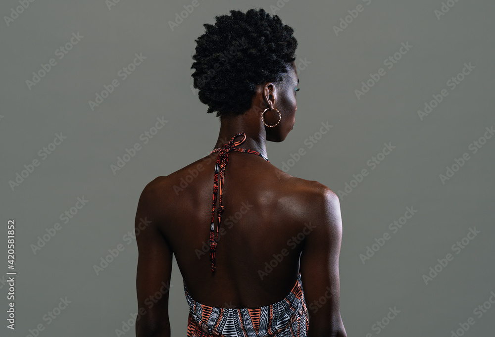 Back view of black african woman posing in the studio isolated on white