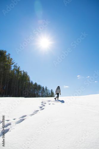 Woman snowshoeing in the snow in the winter