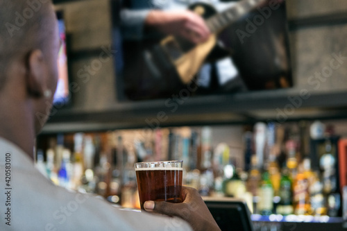 Wallpaper Mural Man In Bar Watching Livestream Concert With A Beer Torontodigital.ca