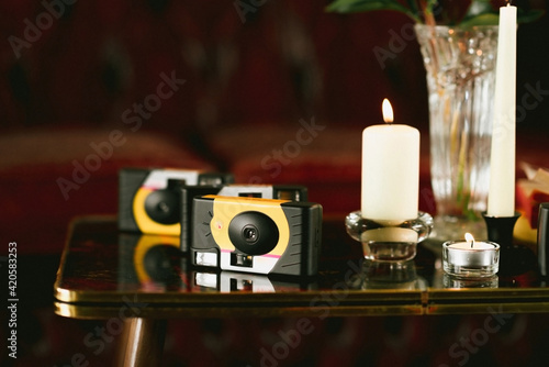 disposable cameras on a small table with candles photo