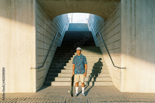 Male skater standing near steps photo