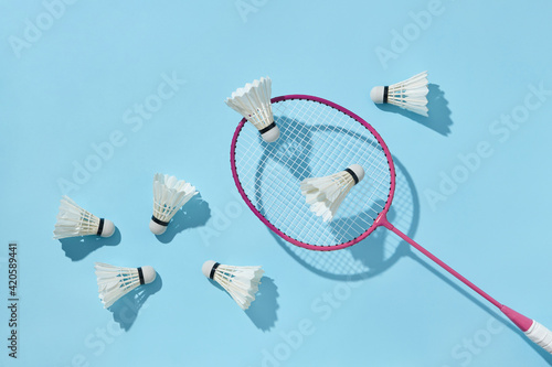 Badminton racket with feathered shuttlecocks. photo