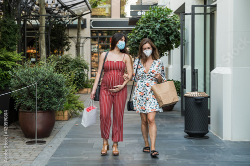 Pregnant lesbian couple doing shopping during covid19