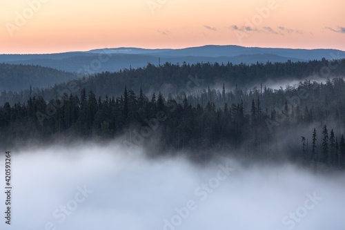 Dawn over a fog covered valley photo