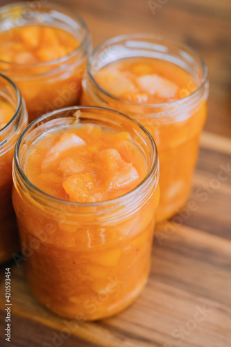 Woman preparing peach preserve photo