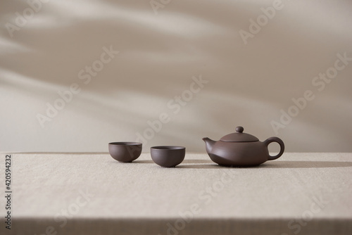 clay teapot for the tea ceremony. there are 2 ceramic tea files on the stand