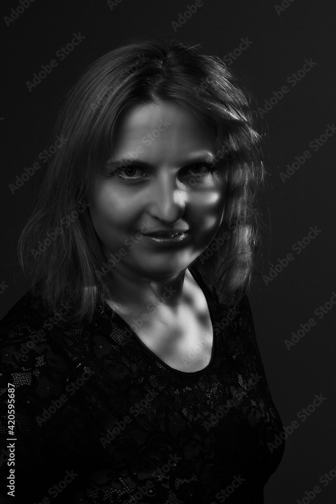 black and white portrait of an overweight woman. Art photography with unusual shadows