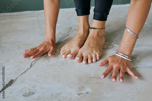 foots and hands beautiful woman practicing yoga at home photo