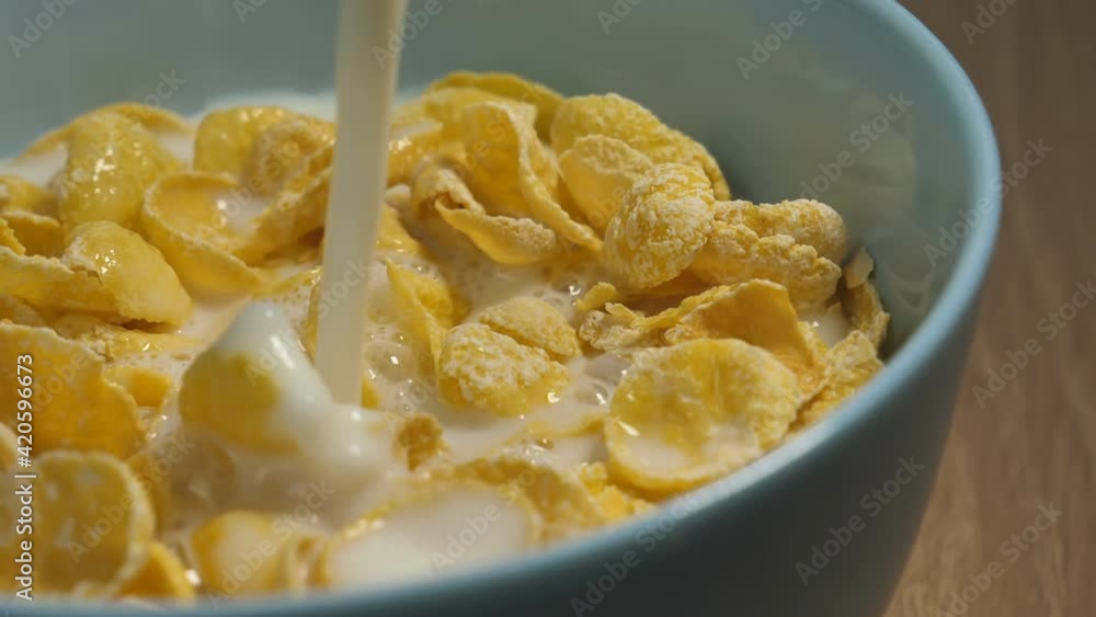 Milk Pouring into a Bowl of Cereal Splashing in Slow Motion Shot at 180 fps.healthy cereal breakfast Milk Pouring into a Bowl of Cereal Splashing in Slow Motion Shot at 180 fps.healthy cereal breakfast