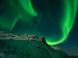 Northern lights over snow covered peaks