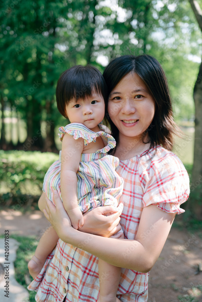 portrait of Asian mother and baby girl outdoor portrait of Asian mother and baby girl outdoor