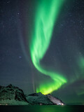 Wild northern lights dancing over nordic mountains