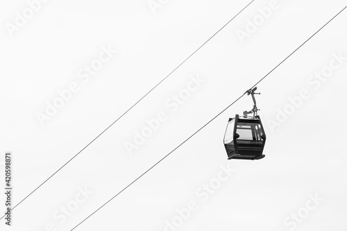 Empty cable car against a cloudy sky photo