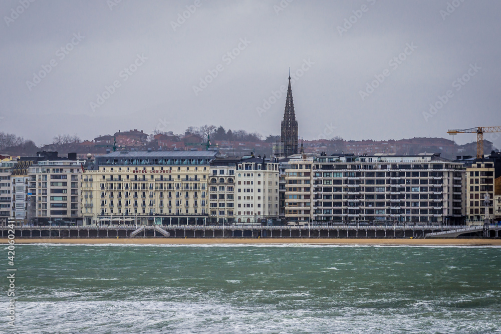 Naklejka premium Coast in San Sebastian, view with cathedral tower, Spain