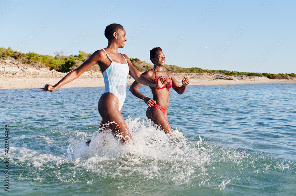 Friends running into the ocean Friends running into the ocean