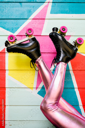 Feet with Roller Skates Kicking in front of Colorful Mural photo