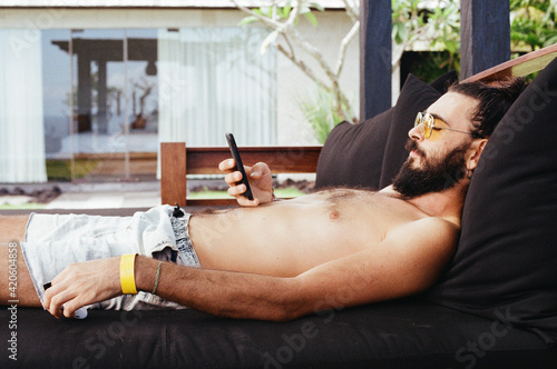 Lying man with phone