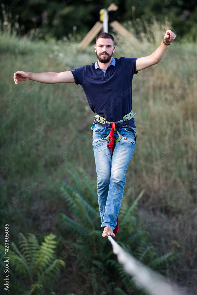 Confident man walking on slackline Confident man walking on slackline