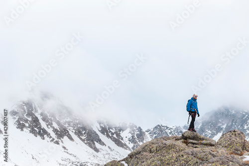 Male explorer in mountains in winter photo