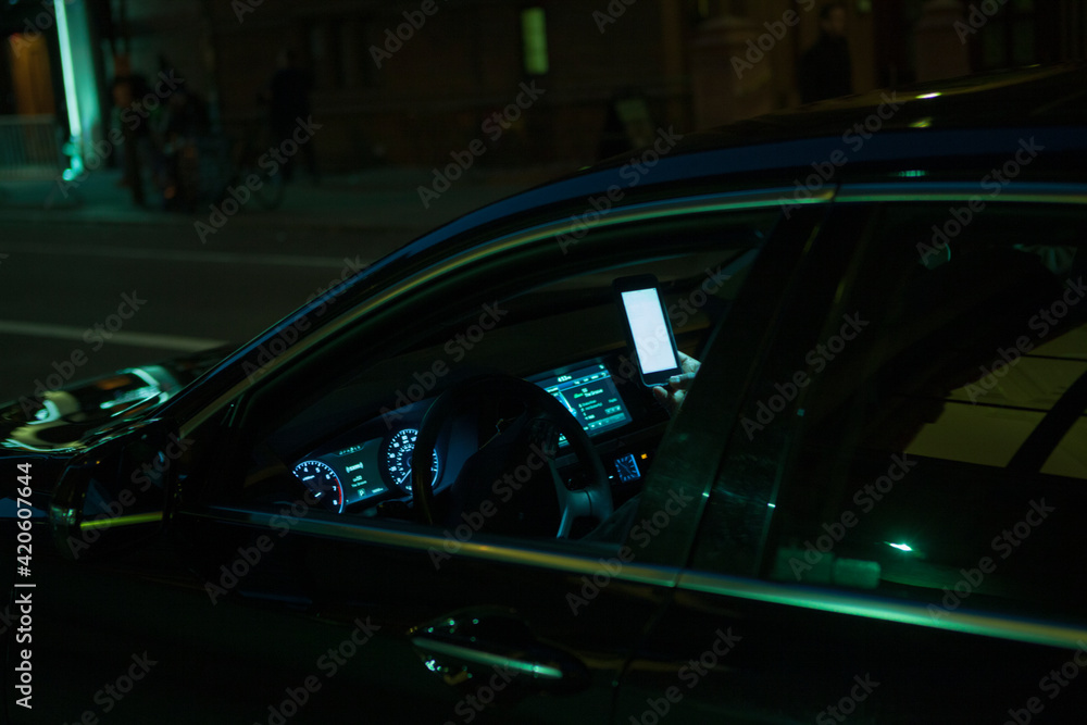 Checking the smartphone in the car, while not driving in a New York city Street. Checking the smartphone in the car, while not driving in a New York city Street.