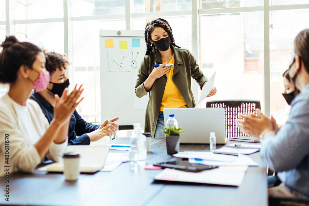 Business team wearing protective masks while meeting in the office during the COVID-19 epidemic Business team wearing protective masks while meeting in the office during the COVID-19 epidemic