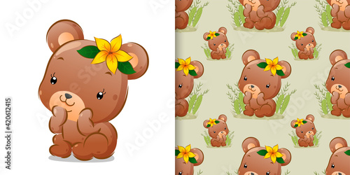 The pattern of the bear sitting on the grass with flower on its head