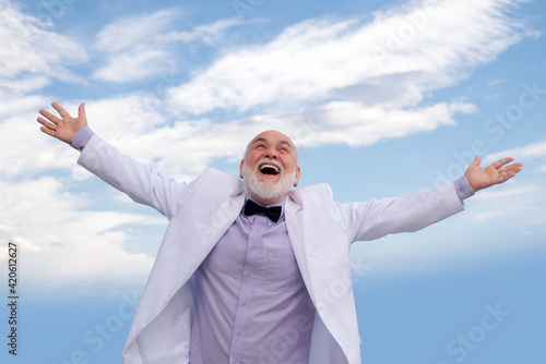 Carefree lifestyle. Old fashion mature man. Success male in white vintage suit having fun outdoor.