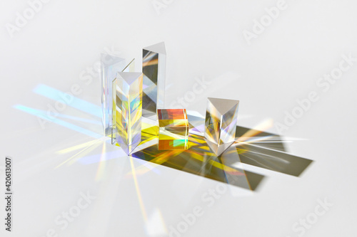 Geometric glass figures with light spectrum refraction.