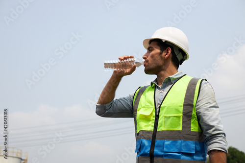 Engineer drinking water.